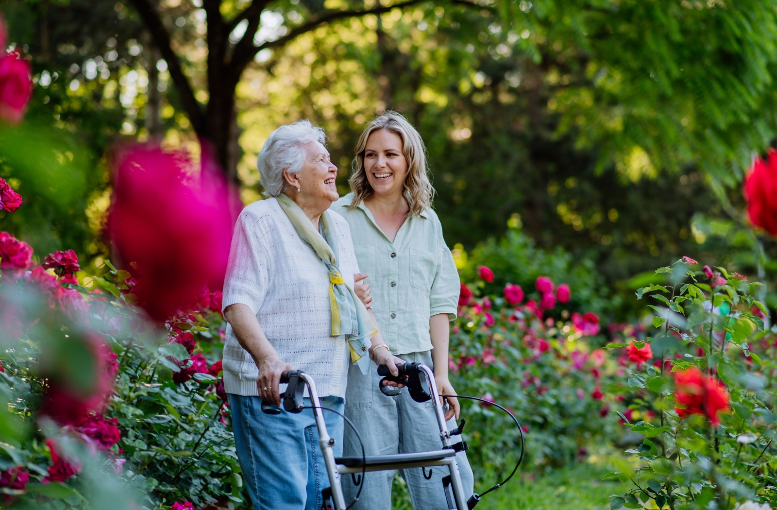 Senior walking in nature during spring with adult daughter